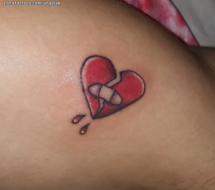 Red broken heart with bandage tattoo on chest for men