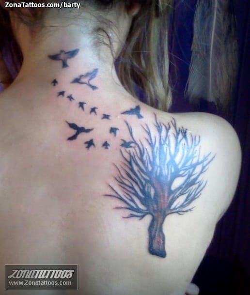 Pine tree tattoo on the left shoulder